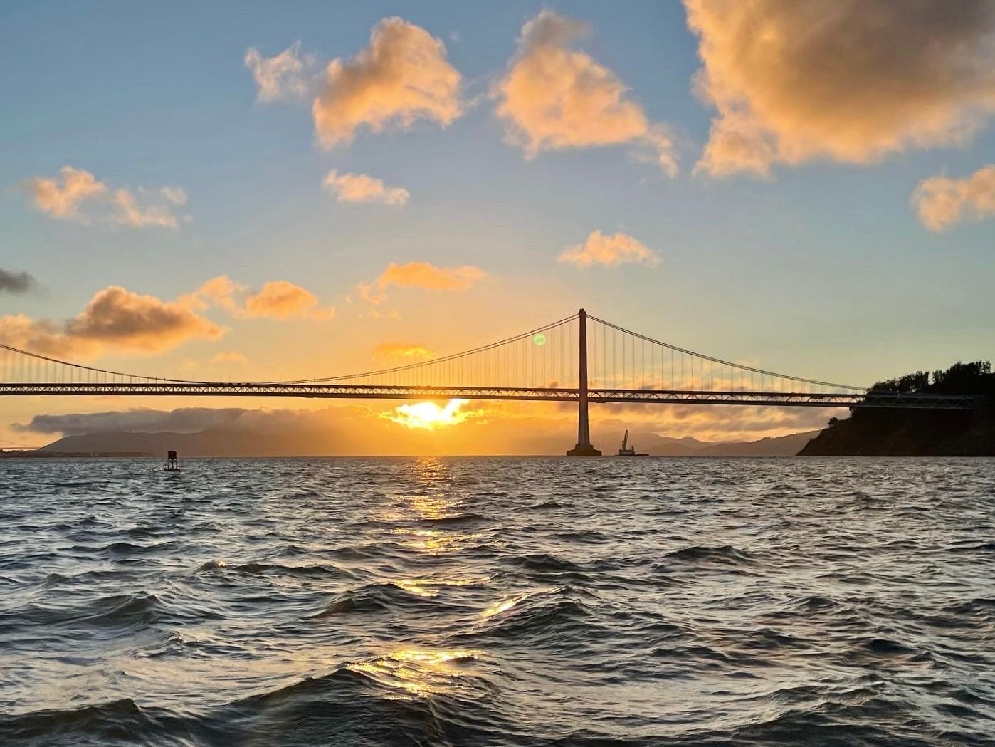 The Golden Gate Bridge at sunset, seen from the water on San Francisco Bay