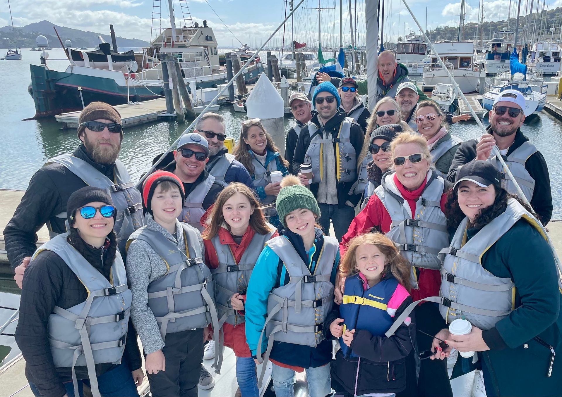 A group of guests in life jackets aboard before a charter in Sausalito